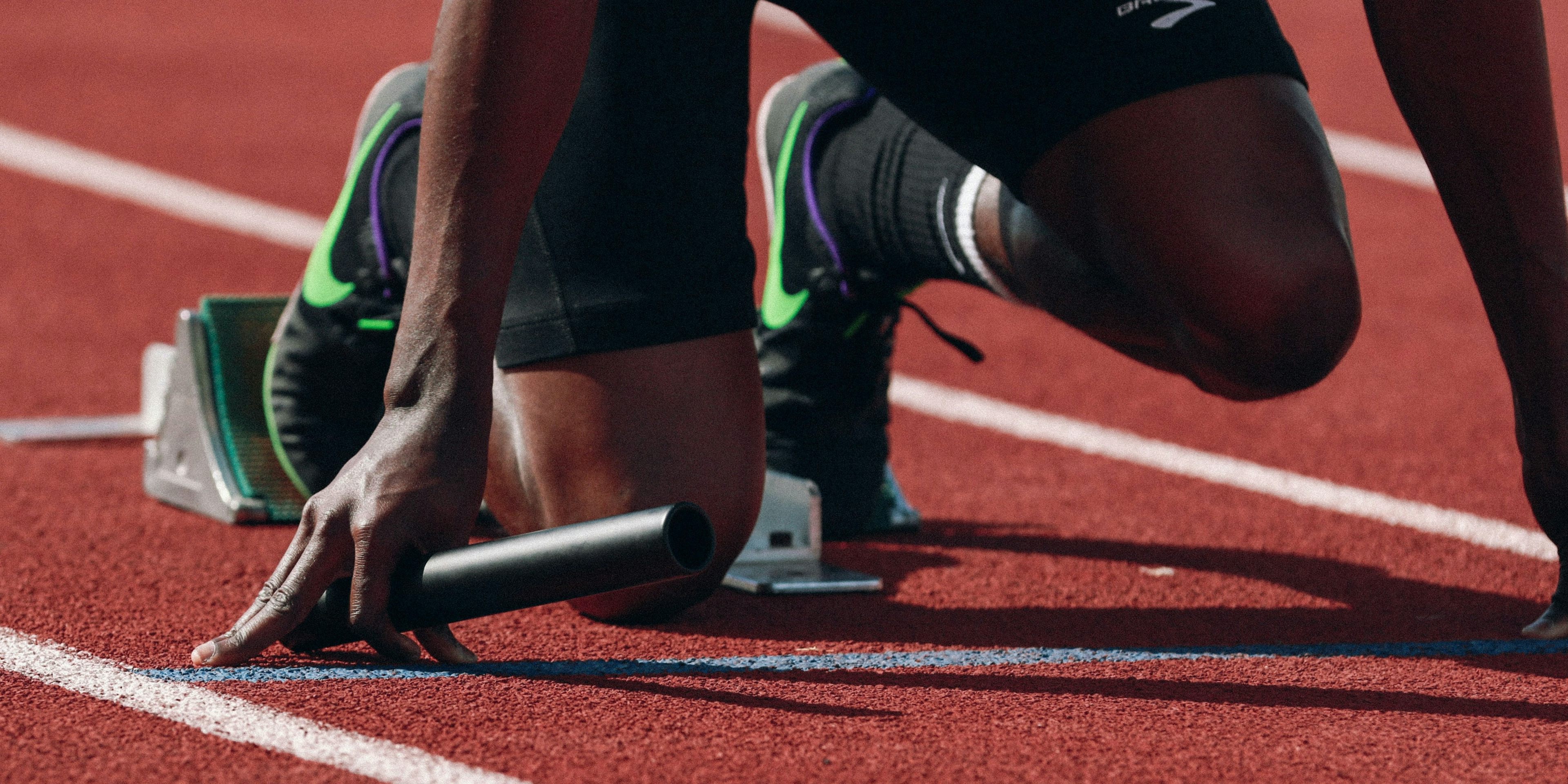 Athlete with foot in starting blocks on a track